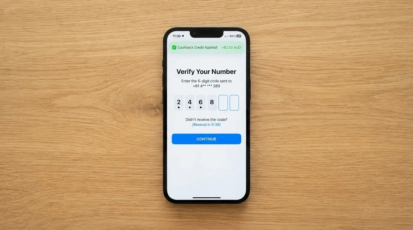 A smartphone showing a phone-number verification screen with a small cashback credit notification appearing